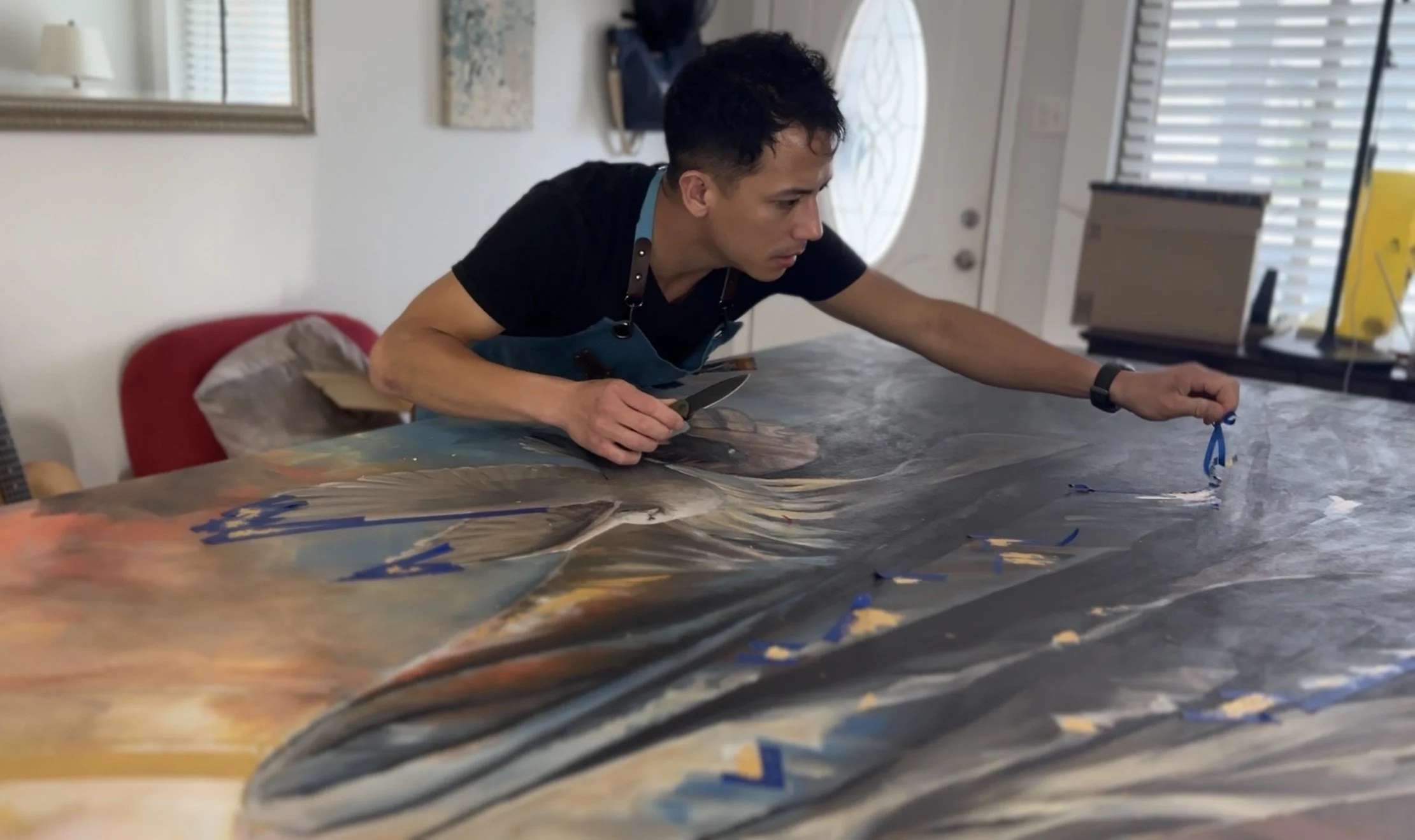 Joe Bertucci working over the large Behold painting in his studio