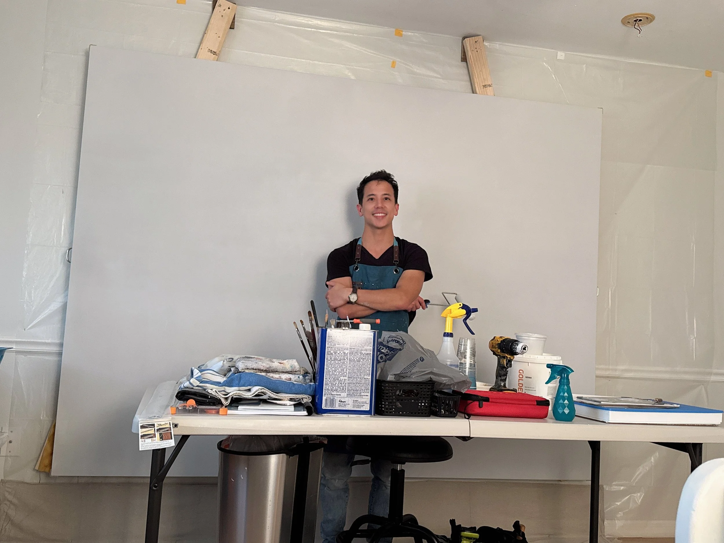 Joe Bertucci in his studio beside painting materials