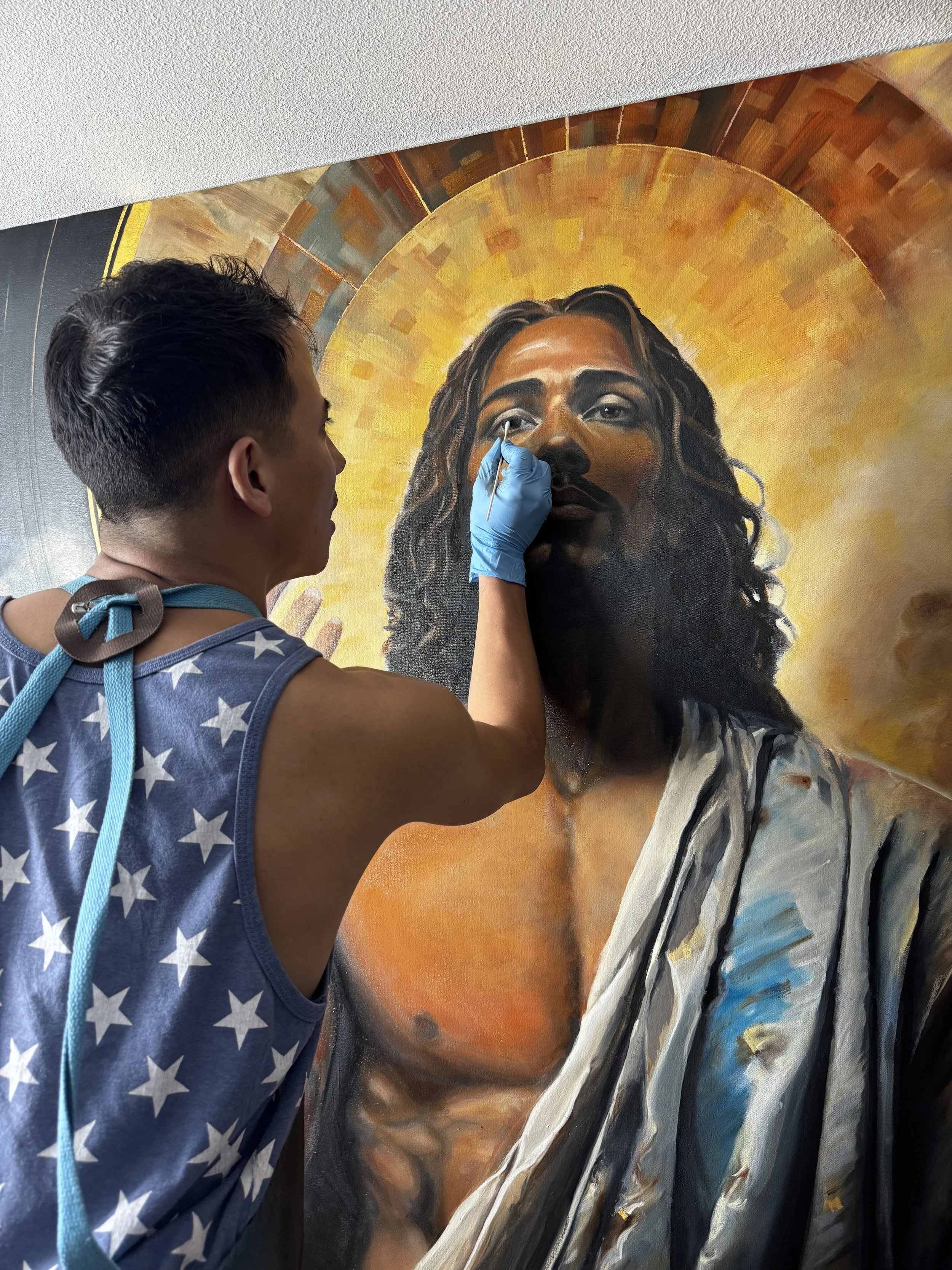 Joe Bertucci painting Christ’s face and halo