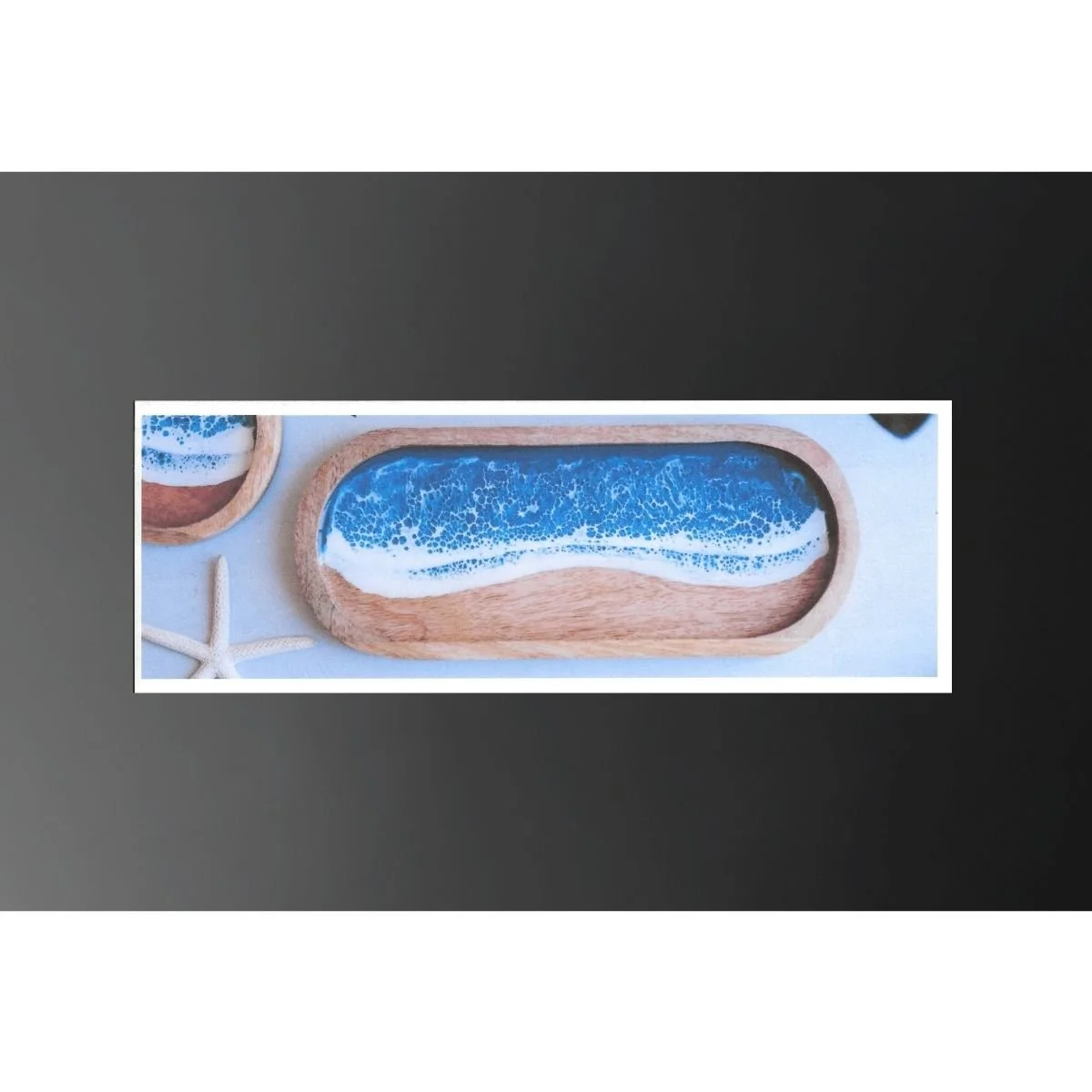 Wooden tray with resin art resembling ocean waves, accompanied by starfish and seashells.