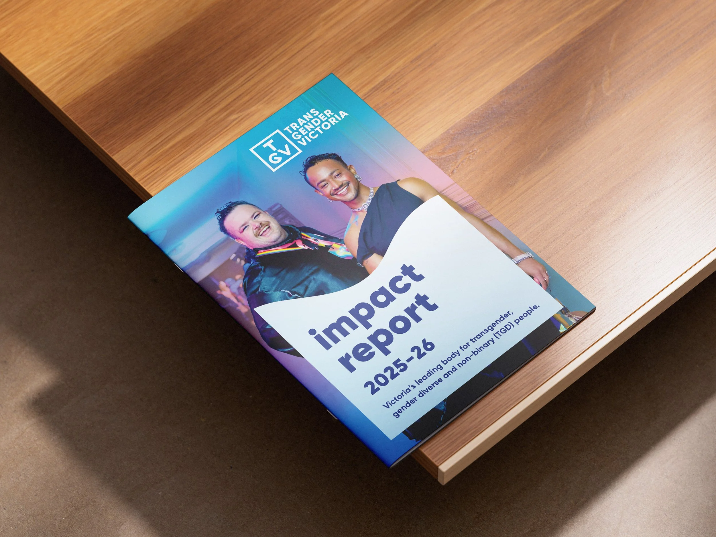 Colourful A4 brochure lying on warm wooden table