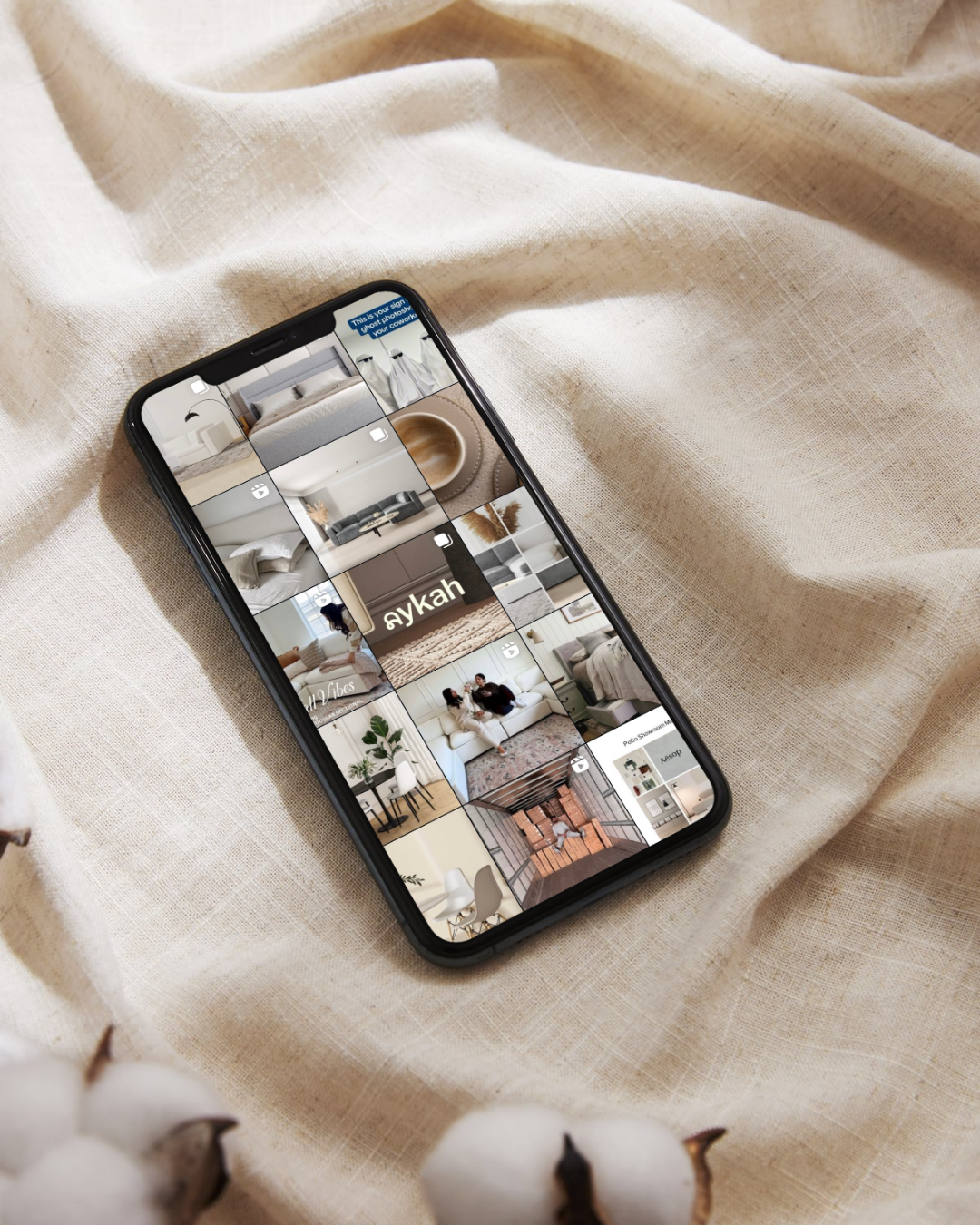 Smartphone displaying a grid of interior design or home decor photos on a beige fabric background.
