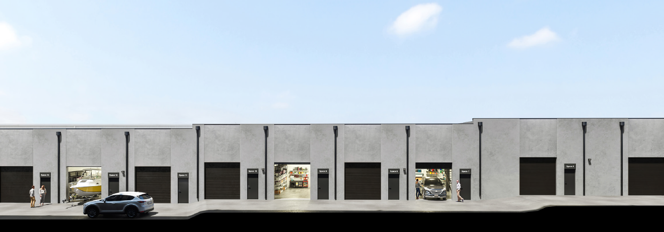 A large warehouse with multiple garage doors, some open revealing storage inside, and people walking nearby.