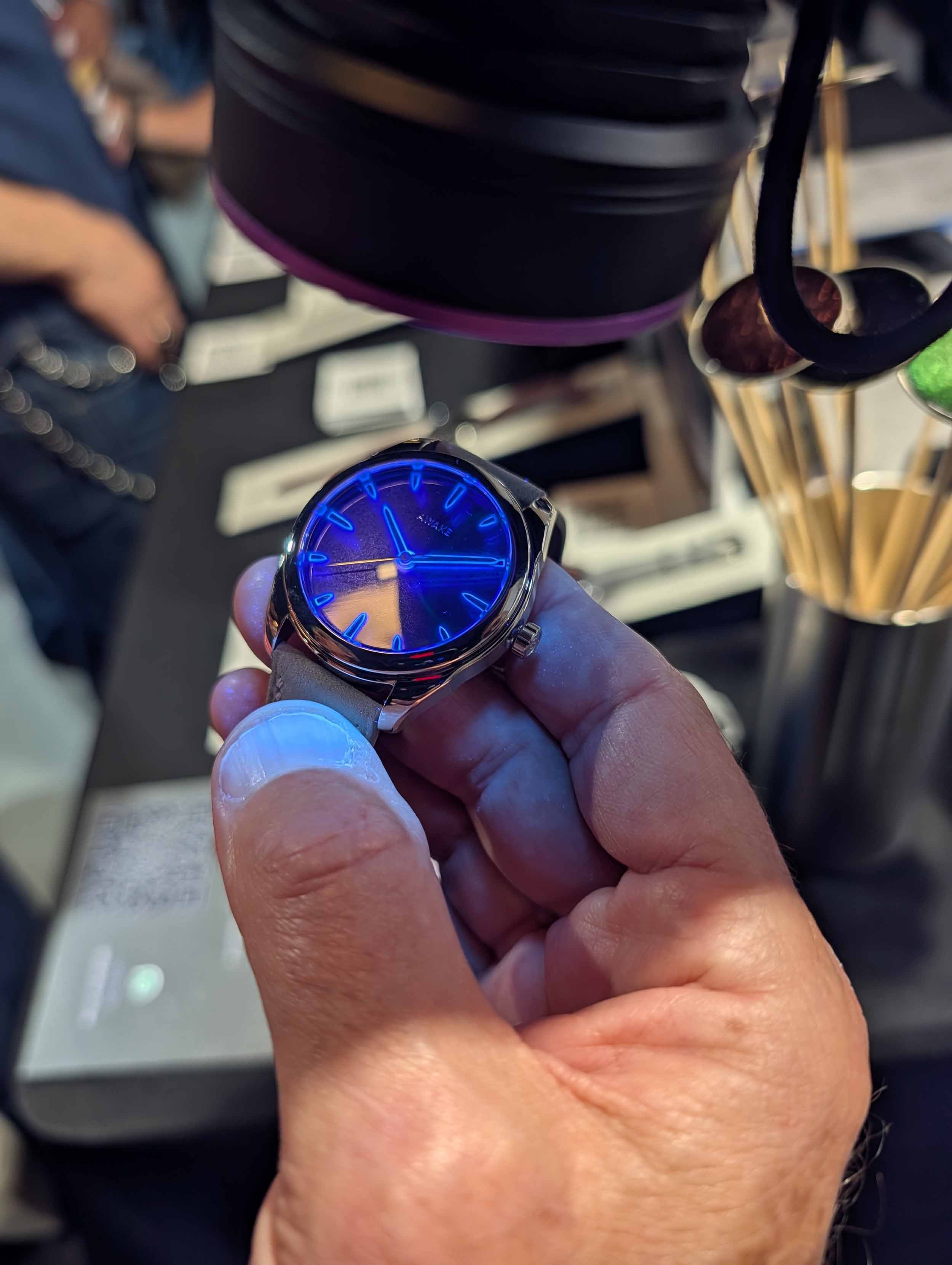 Awake Son Mai watch glowing under UV light.