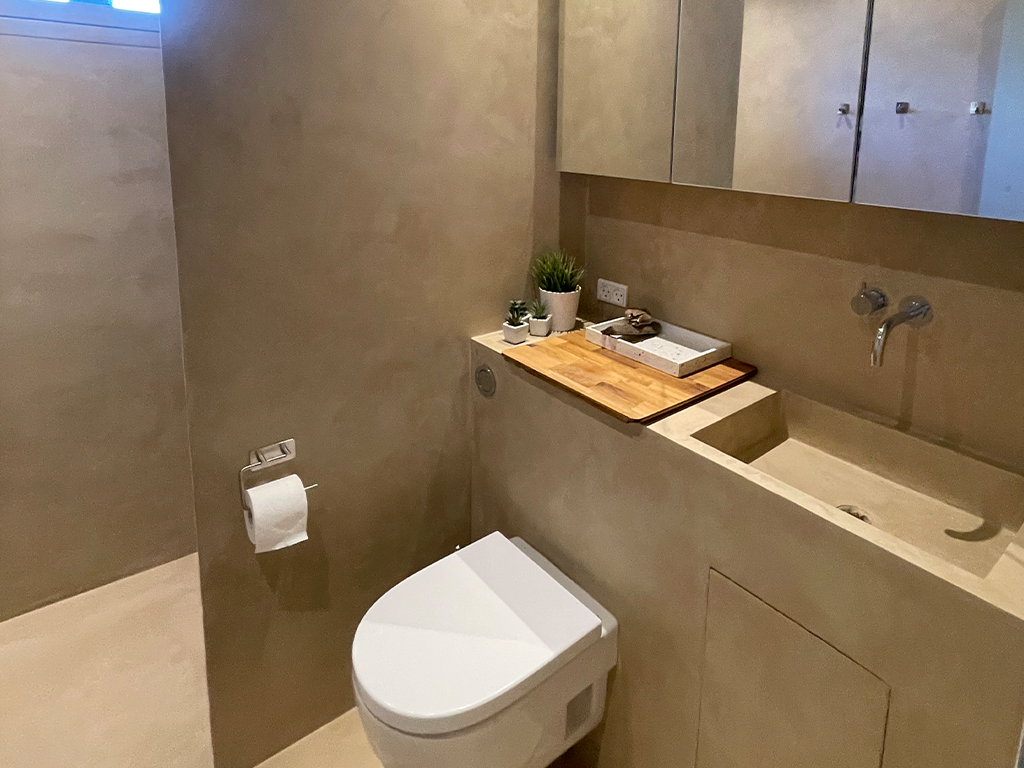 bathroom in microcement beige color