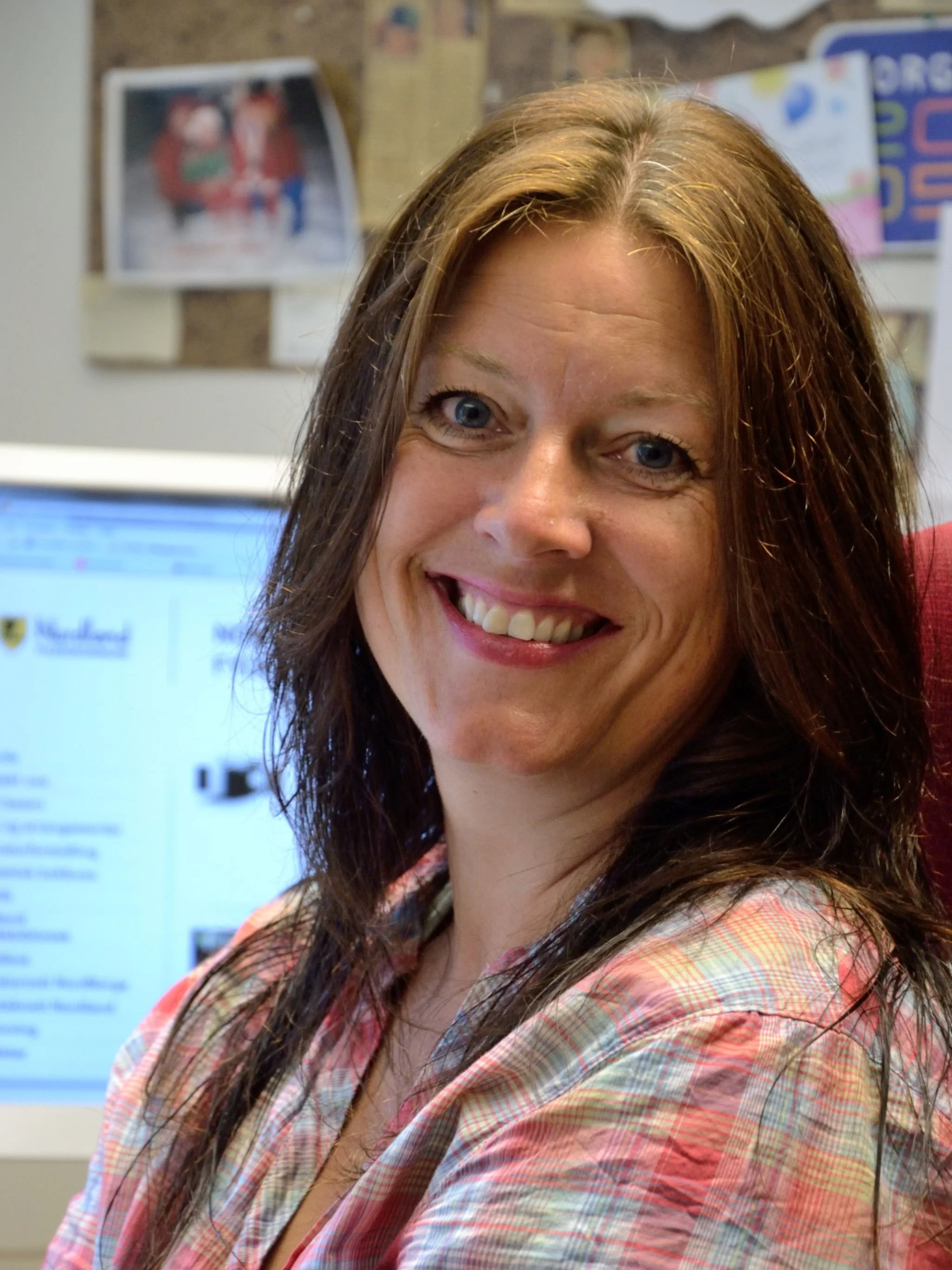 A woman looking at the camera smiling