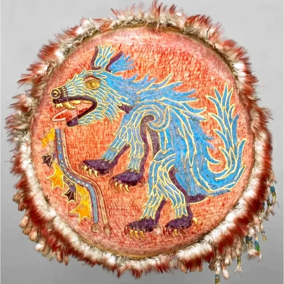 A decorative drum with a painted blue lion holding a staff on an orange background, surrounded by a feathered border.