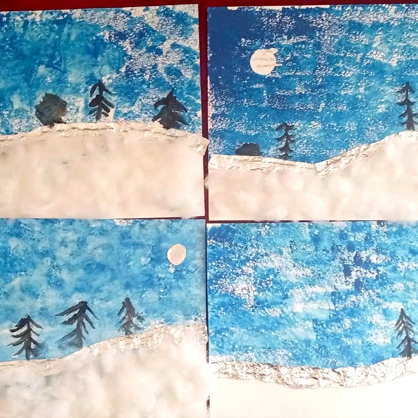 Four scenes depicting a winter landscape with snow-covered hills, evergreen trees, and a sky with either a full moon or a cloudy sky, created with textured paint and collaged paper.