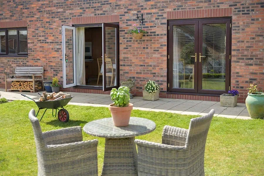 Dual dark woodgrain uPVC French doors.webp