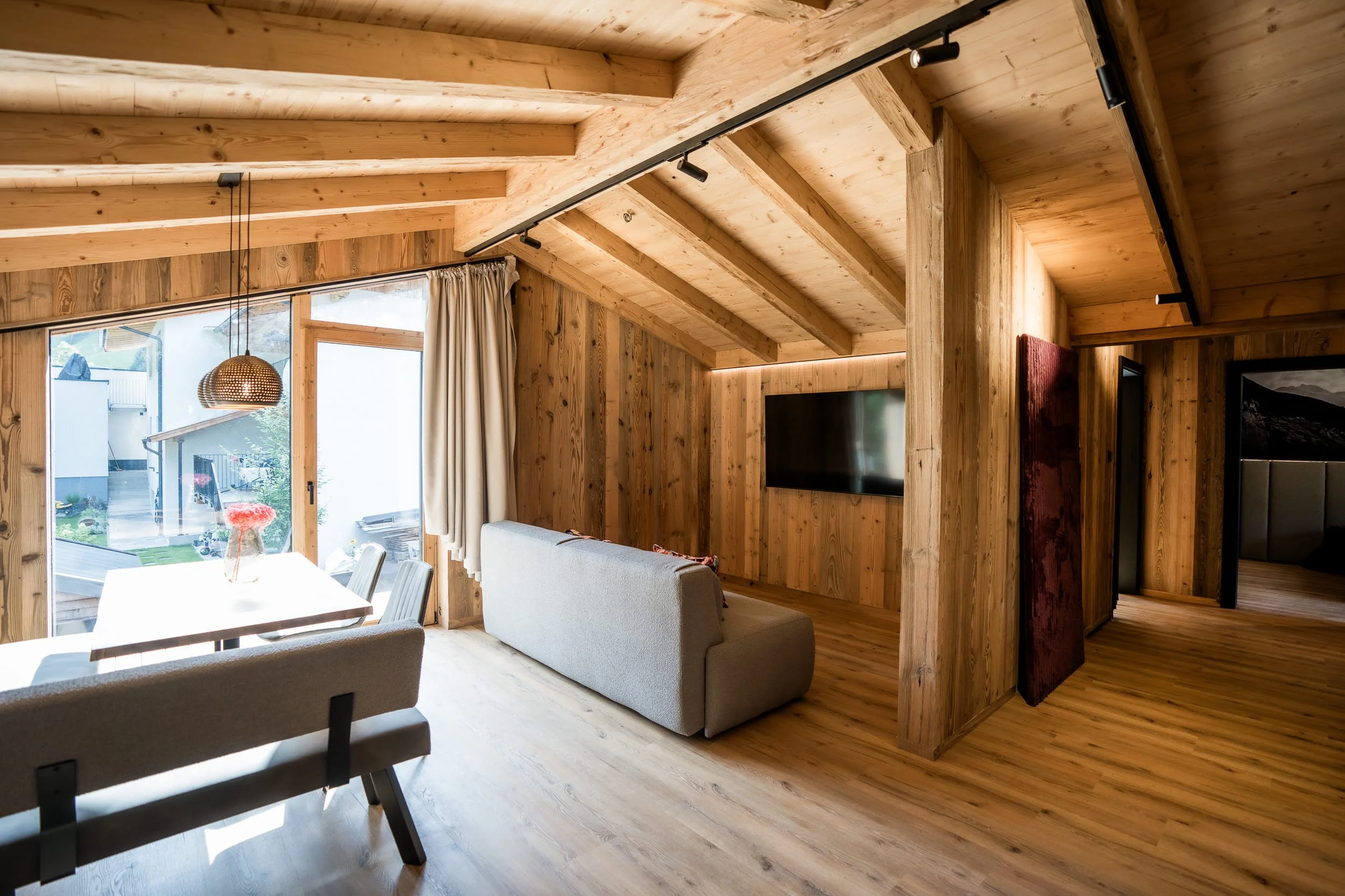 Heller Wohn- und Essbereich im SLØW Chalet mit moderner Einrichtung und großflächigen Fenstern.
