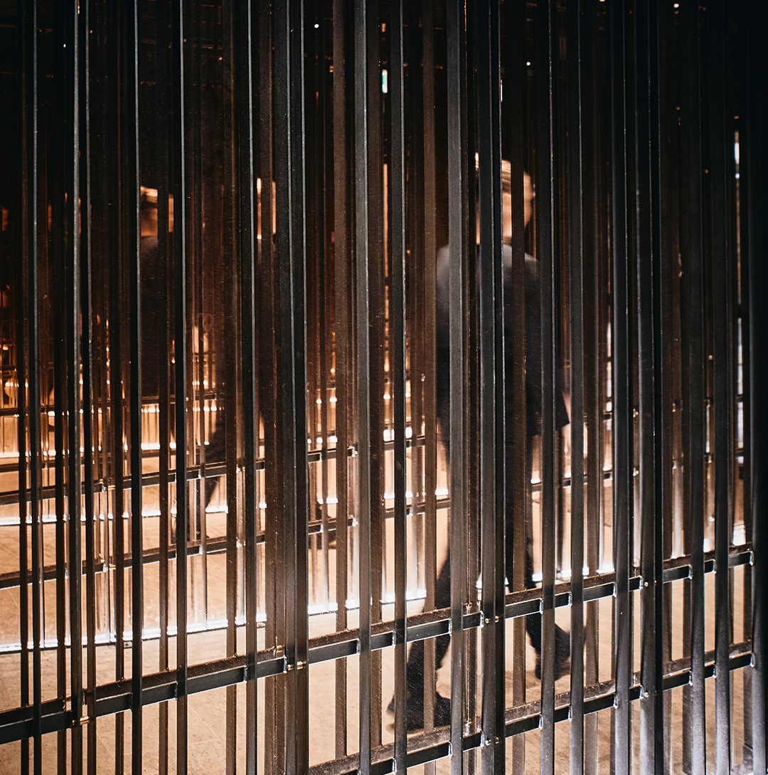 Person standing in a dimly lit setting.