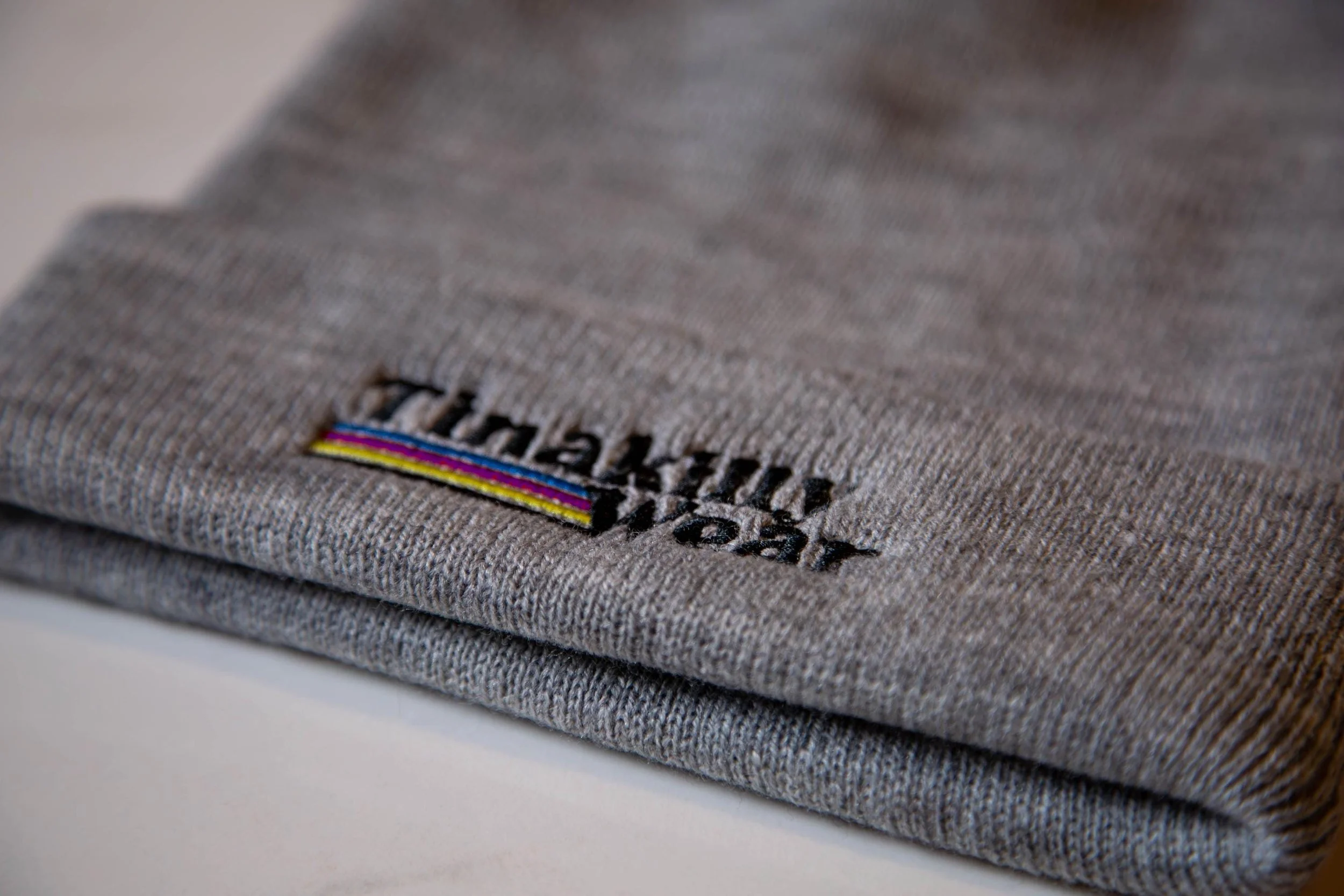 Close-up of a folded gray Patagonia fleece with a small embroidered logo.
