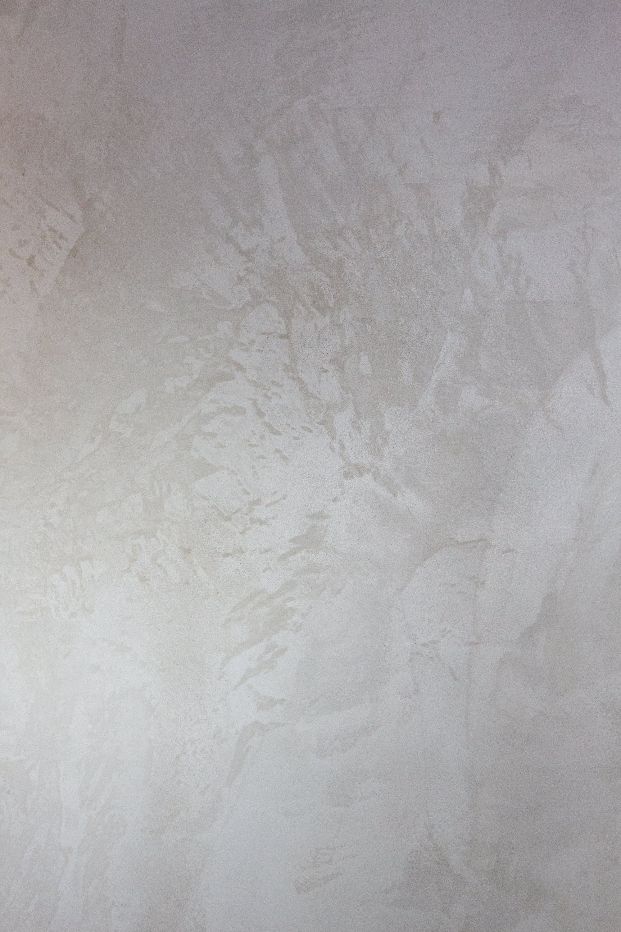 Surface with water stains, streaks, and irregular patterns.