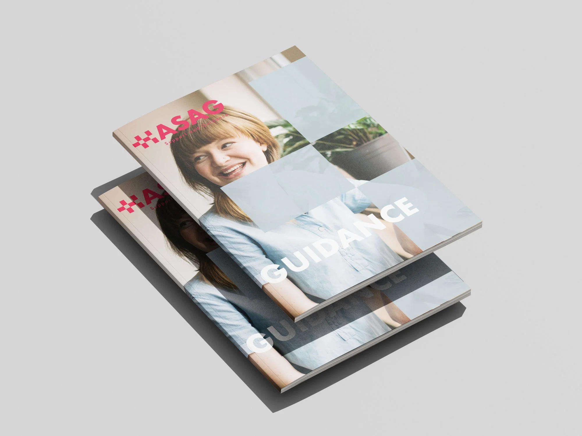 Two brochures or magazines stacked with the top one titled "GUIDANCE" and featuring a smiling woman with reddish-brown hair, wearing a light blue shirt. The magazines have the logo "HASAG" in pink at the top left corner.