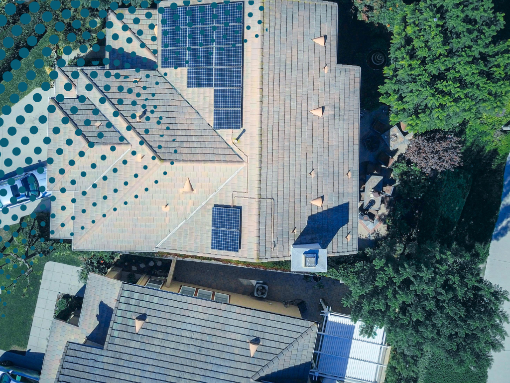 Image of a house from above showing solar panels on the roof.