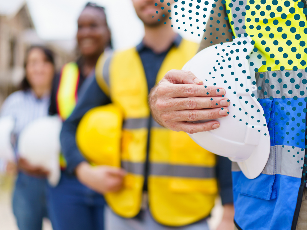 Image of contractors holding hard hats.