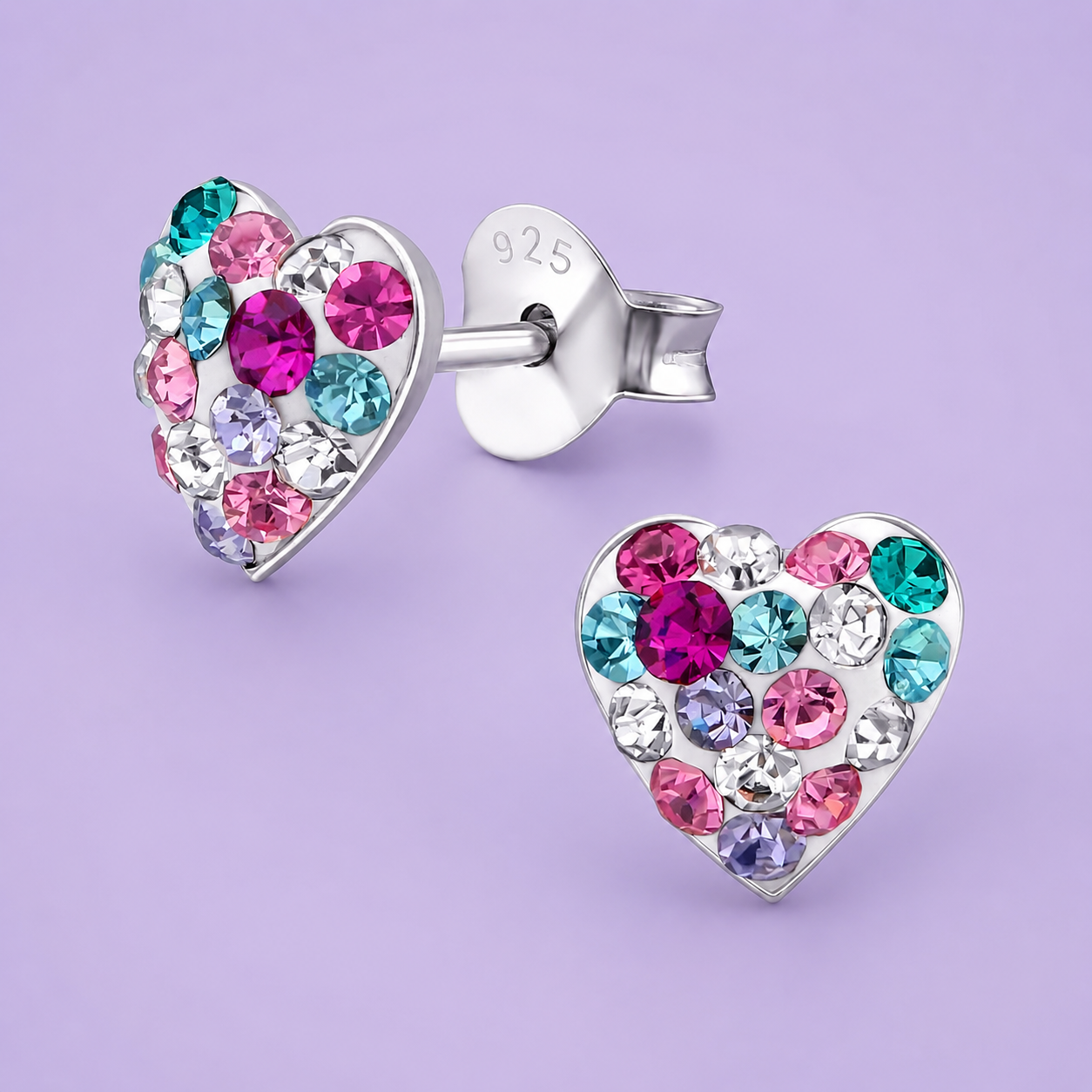 Silver heart-shaped earrings with colorful gemstones on a lavender background.