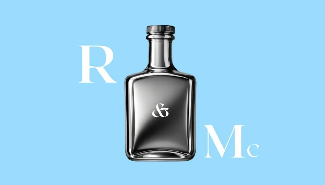 A shiny black perfume bottle with a silver cap on a light blue background, with the text 'R & Mc' in white around it.