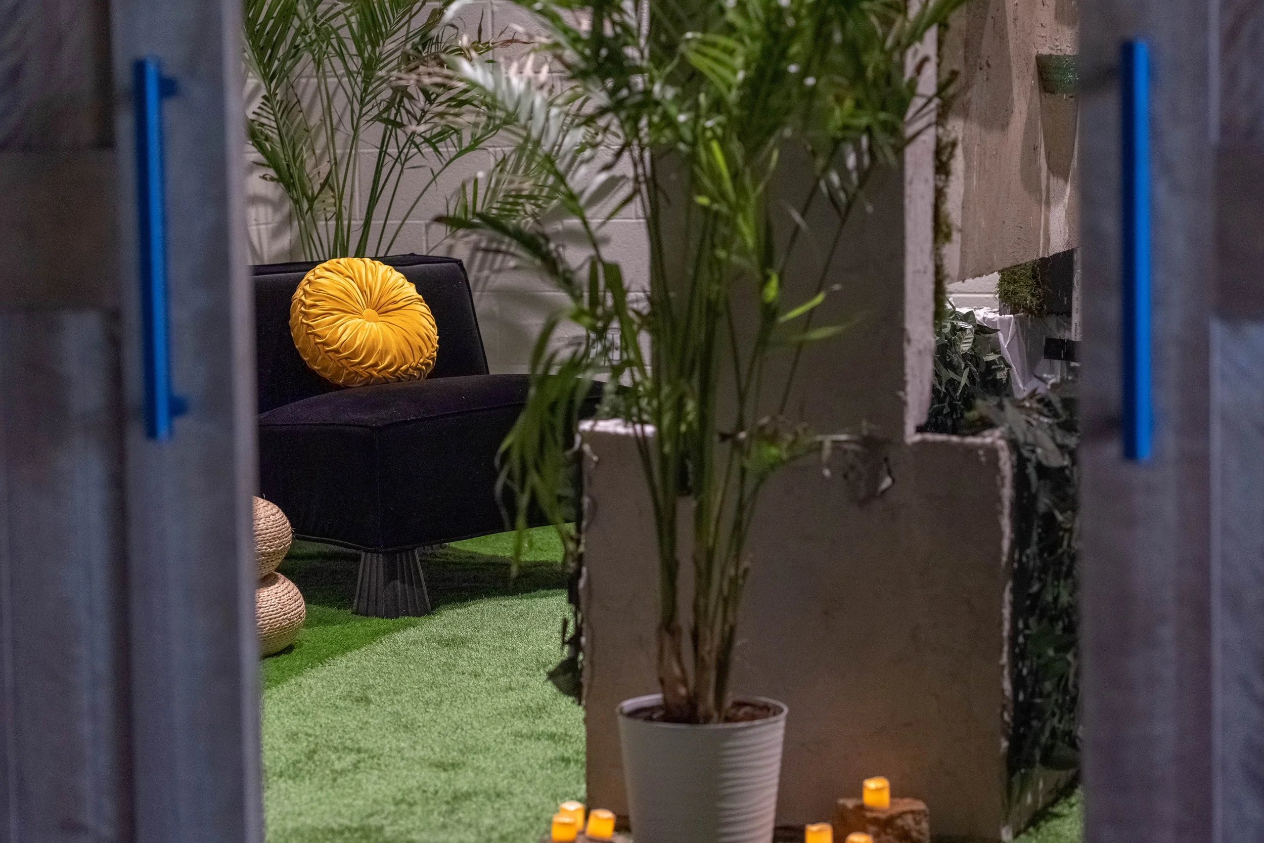 Couches with pillows, plants and waterfall