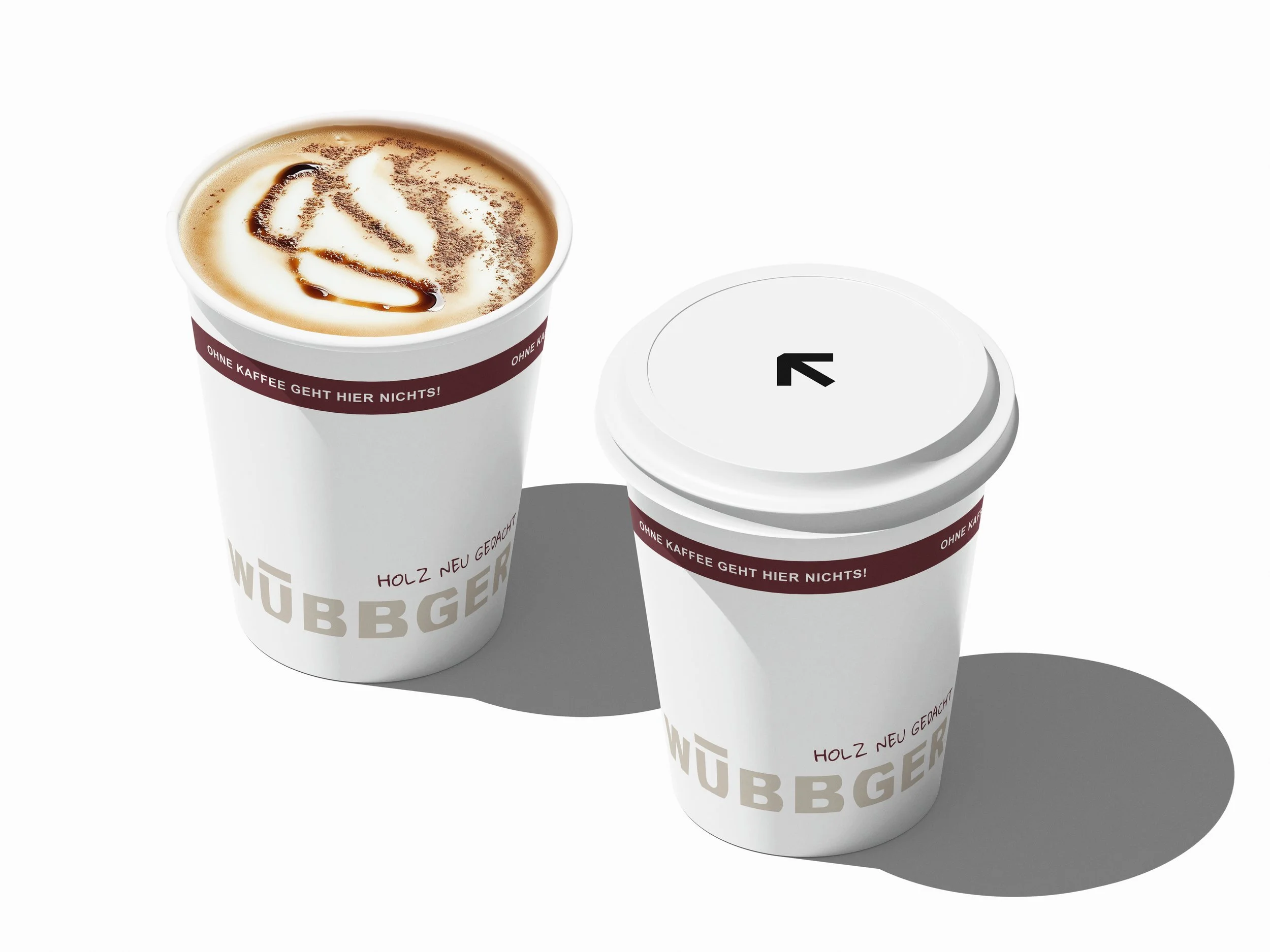 Two white coffee cups with brown bands, one filled with coffee topped with foam and chocolate drizzle, and the other with a closed lid. Both cups have text and are casting shadows on a white surface.