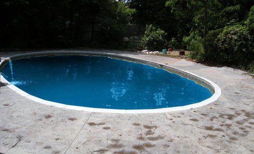 Spartan-Concrete-Services-StampConcretePoolPatio-oval-decorative.jpg