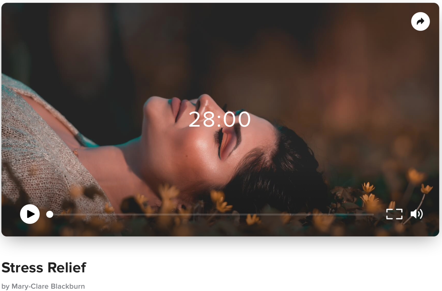 A woman lying on the ground surrounded by yellow flowers with her eyes closed, during sunset or sunrise.