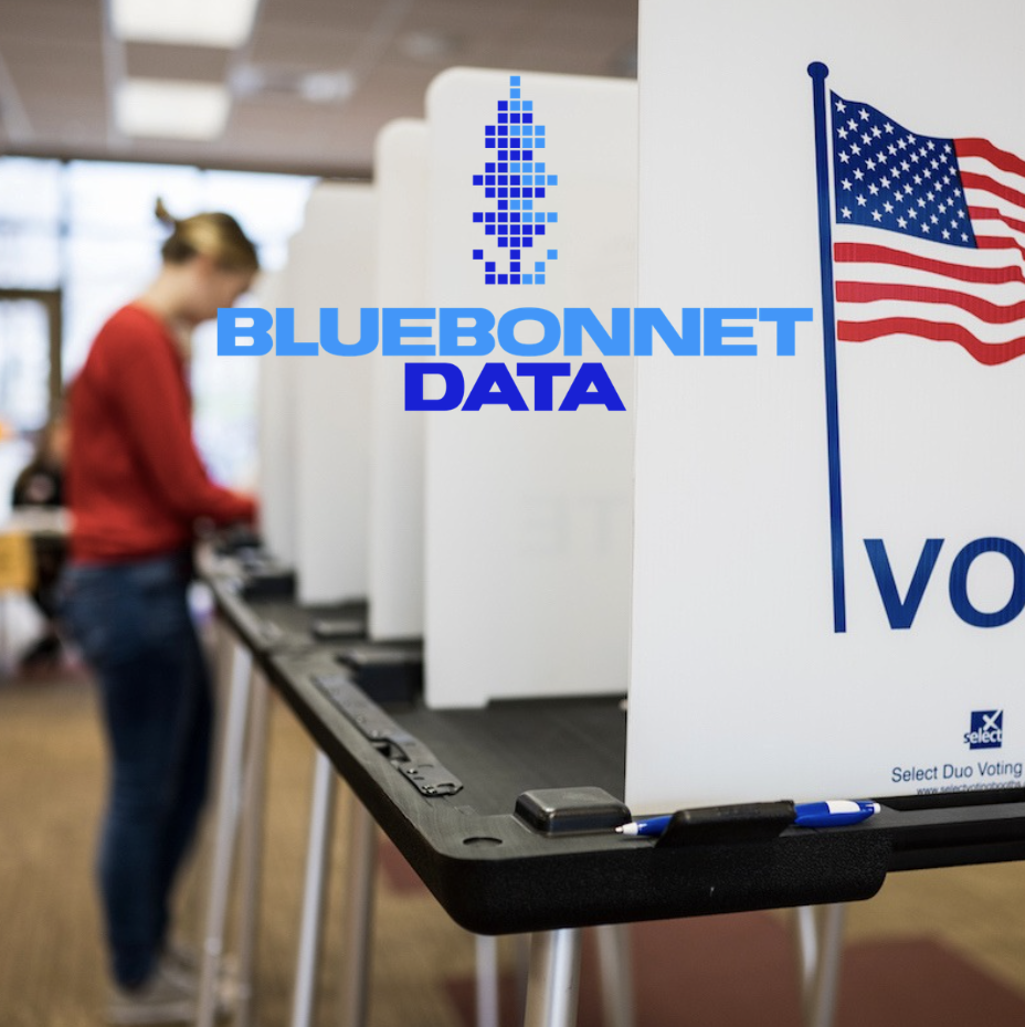 A person casting a vote at a polling station with voting booths and an American flag displayed.