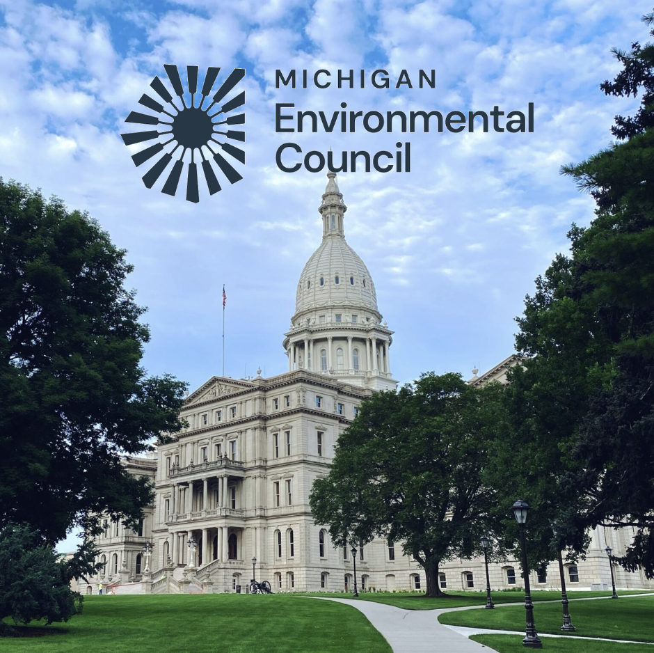 The Michigan State Capitol building with the Michigan Environmental Council logo in the sky above it, surrounded by trees and a sidewalk in the foreground.