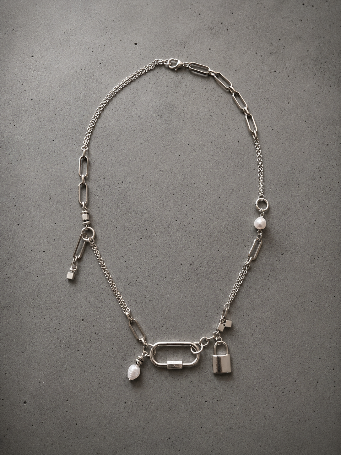 Stainless steel chain necklace in different sizes, with stainless steel charms and natural freshwater pearls.