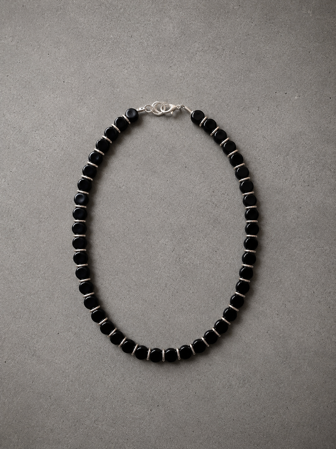 Black acrylic stone necklace with stainless steel charms.