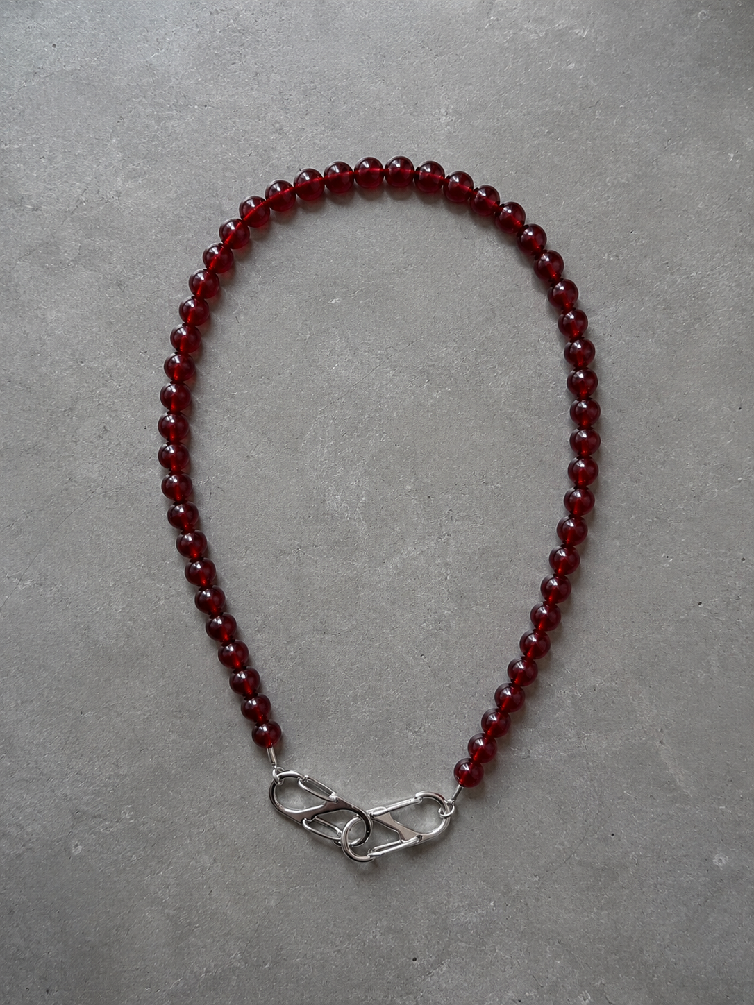 Burgundy acrylic stone necklace with stainless steel lobster clasps.