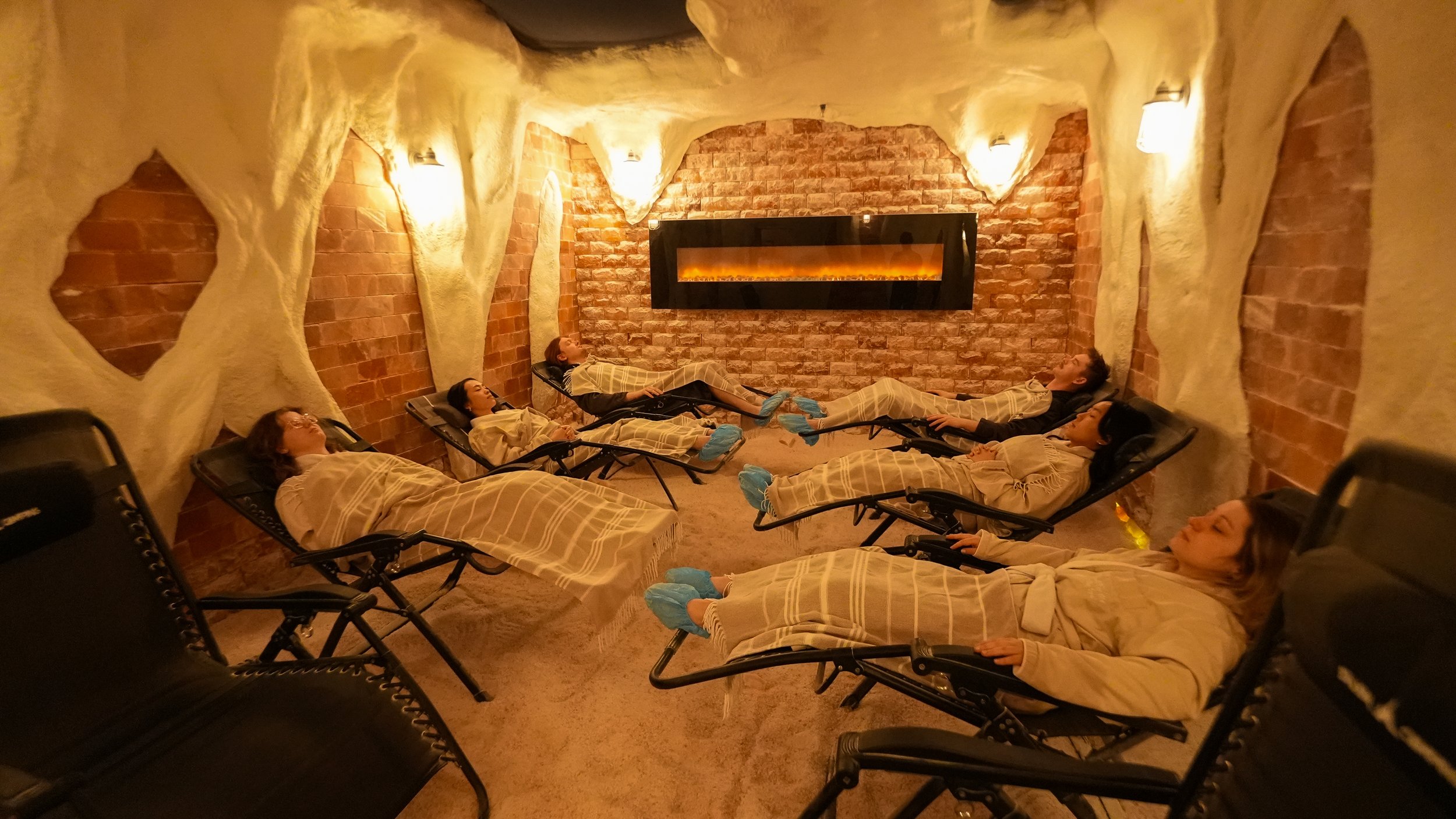 6 people lounging together in the Himalayan Salt Cave