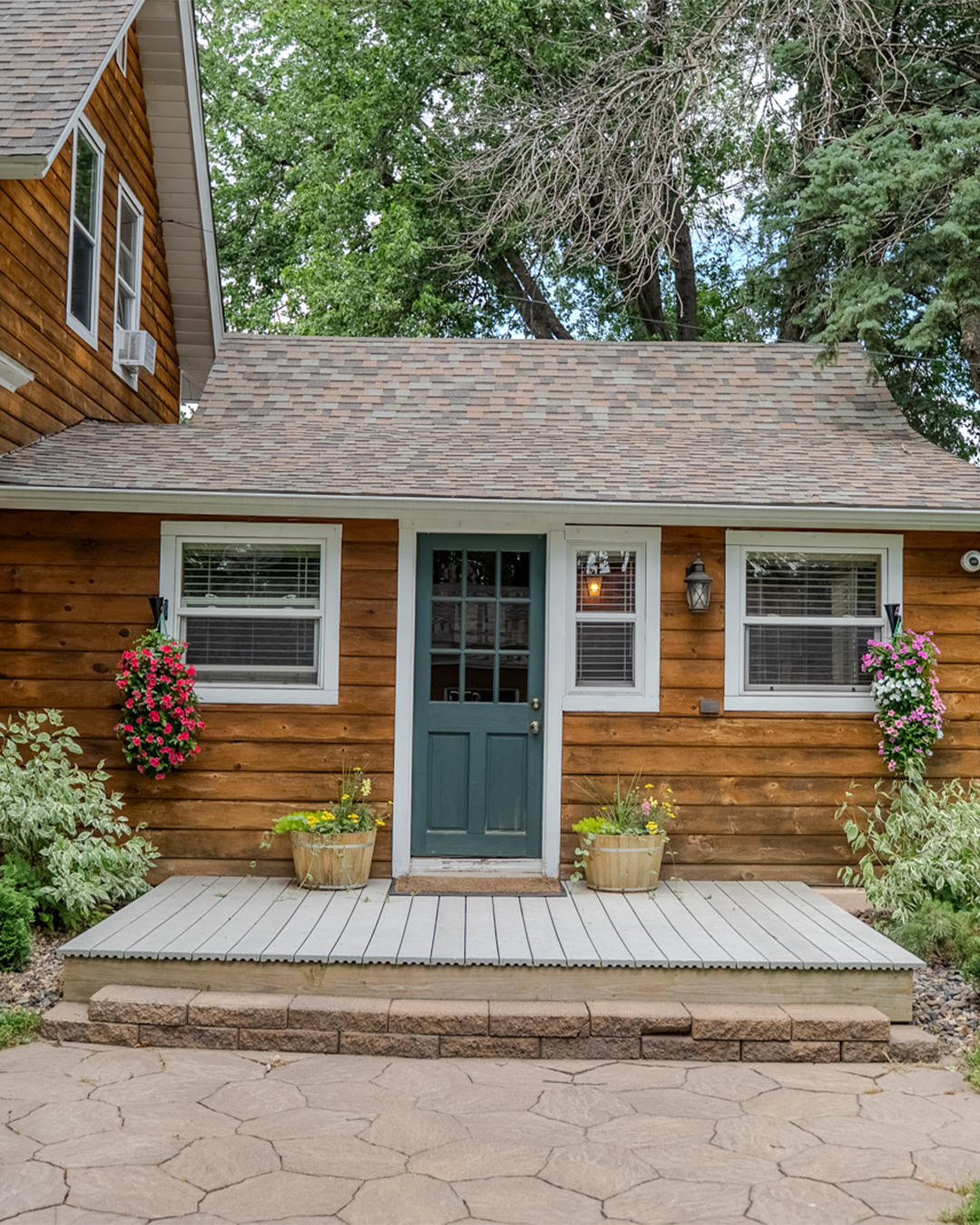 Green side entry door to The Log Cabin home