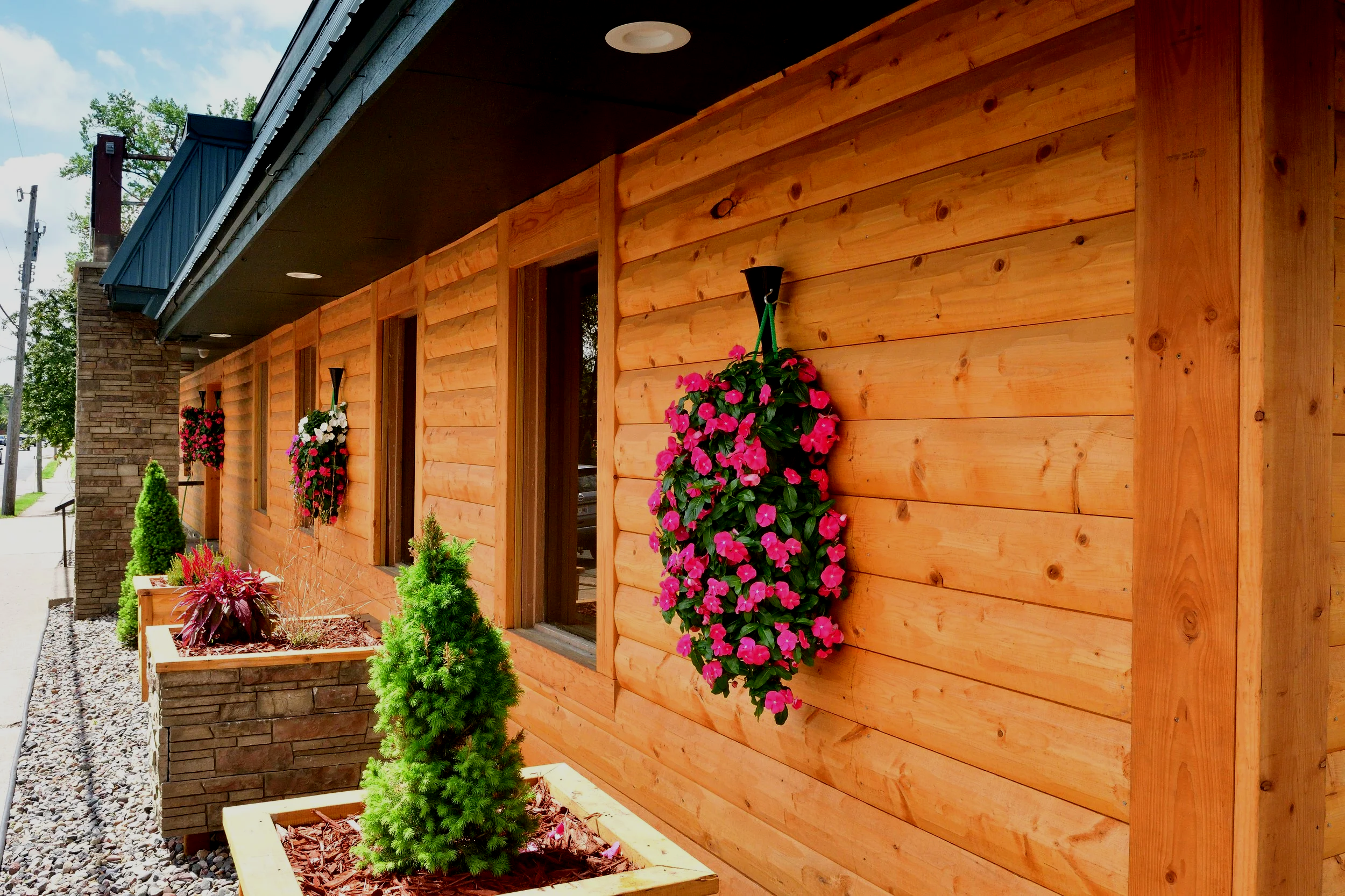 flowers hanging on log cabin building