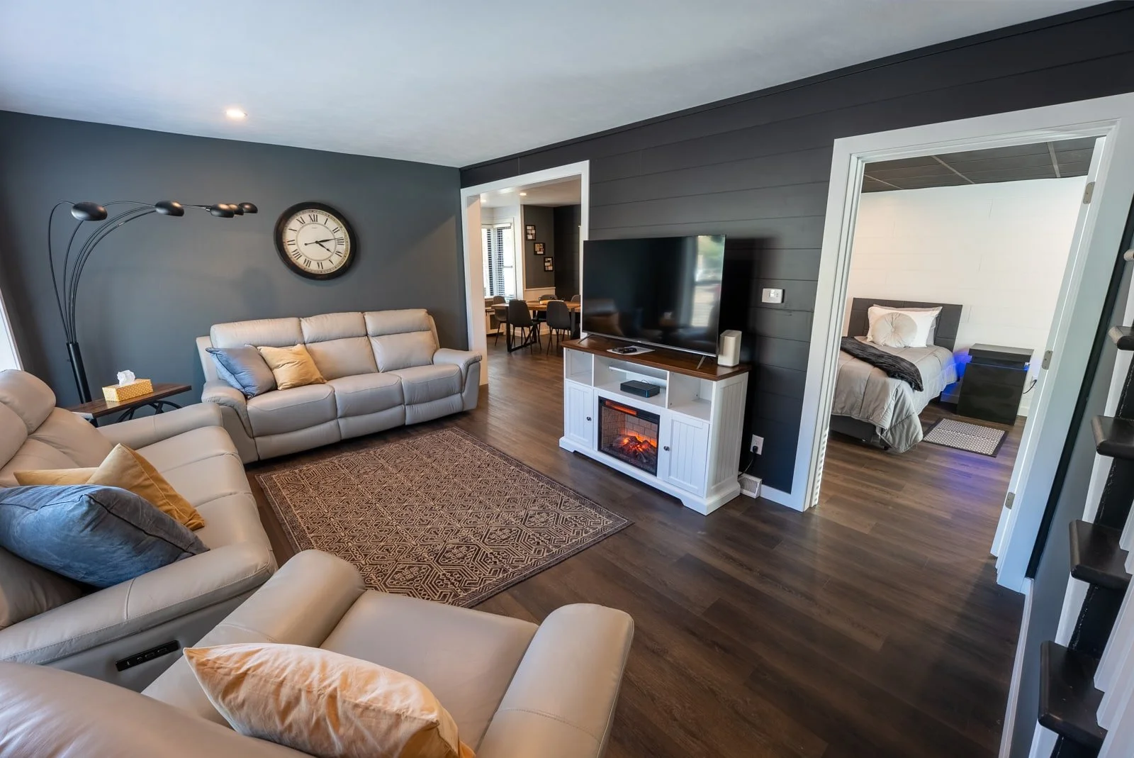 Living room with two couches, chair, fireplace, and TV in The Donovan home
