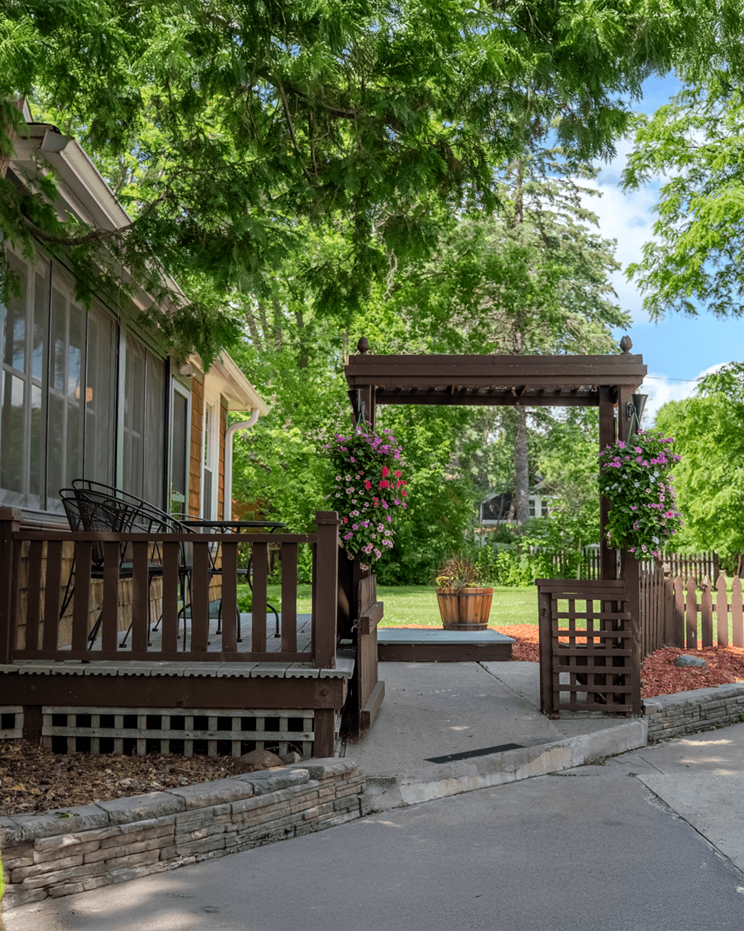 Outdoor area with hanging baskets and sitting area at The Cottage home