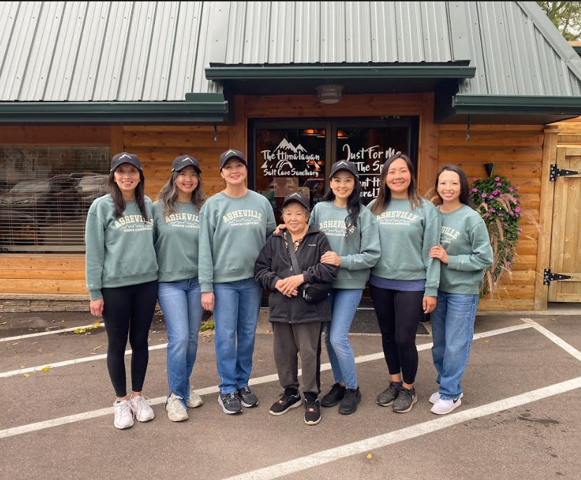 7 women standing together in front of the Just For Me Spa building