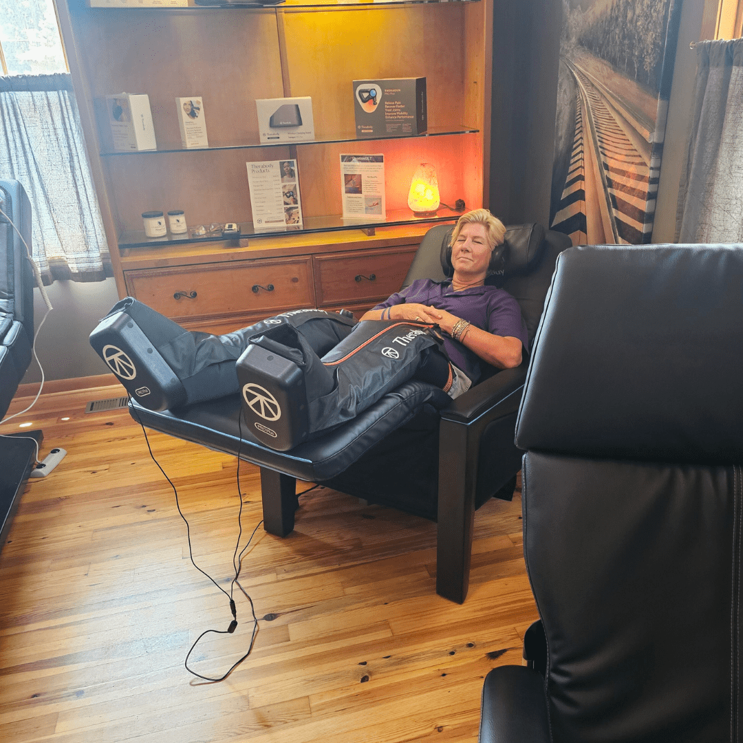 individual experiencing sound & vibration therapy with compression boots