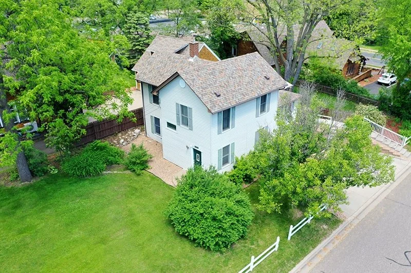 Aerial view of back of The Retreat Home and backyard
