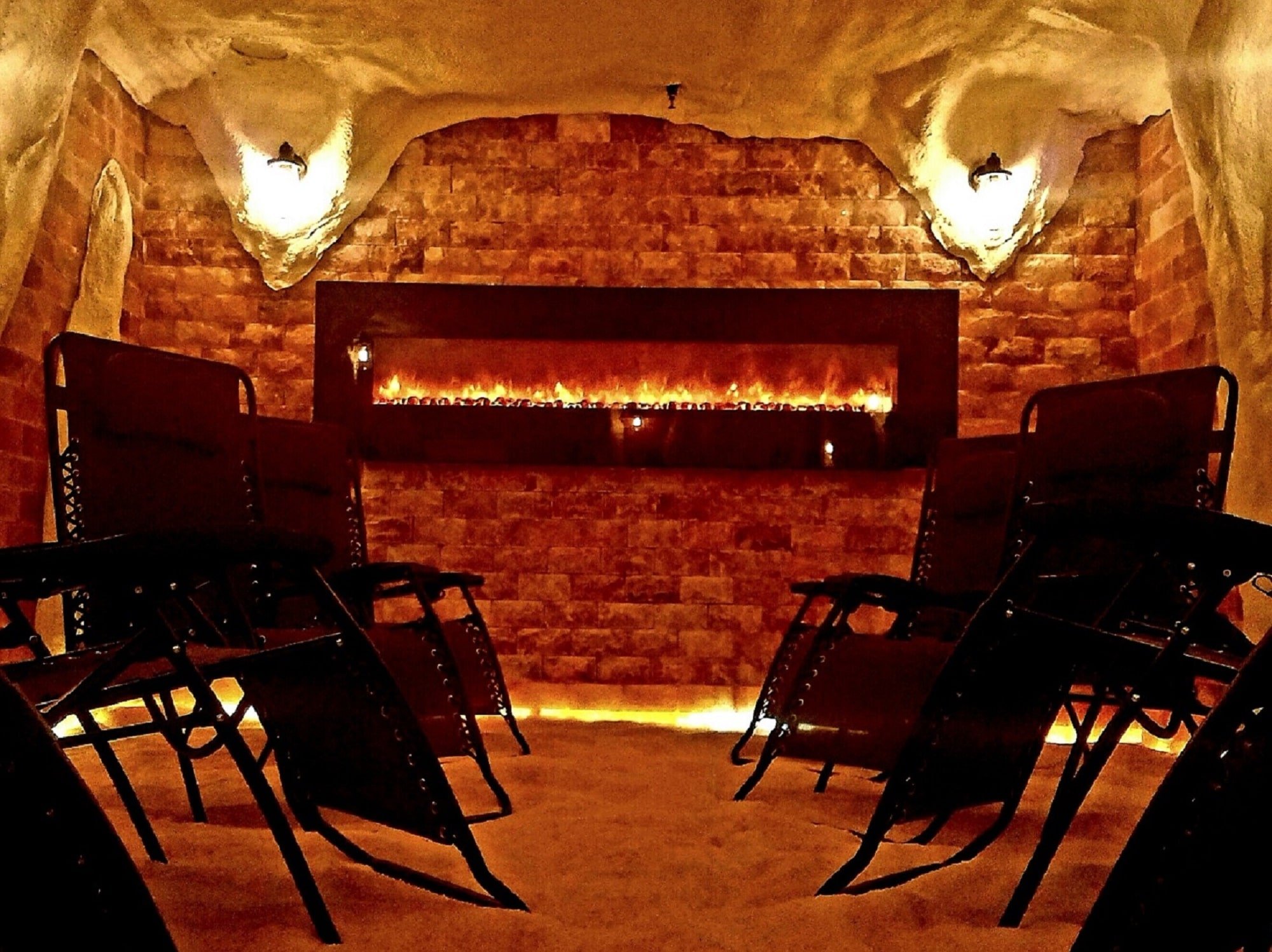 chairs in himalayan salt cave with fireplace on