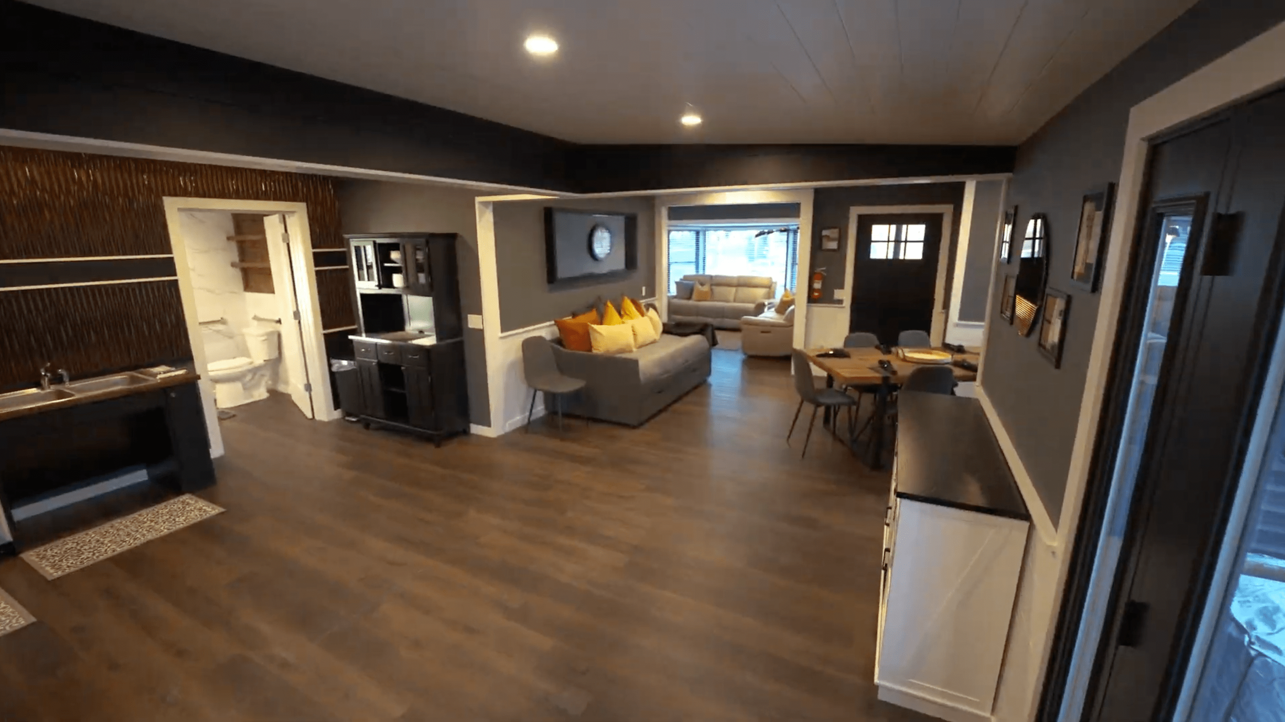 Wide view of The Donovan main level including seating areas, dining, bathroom