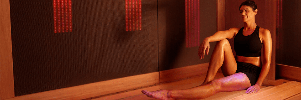 woman posing in infrared light therapy sauna