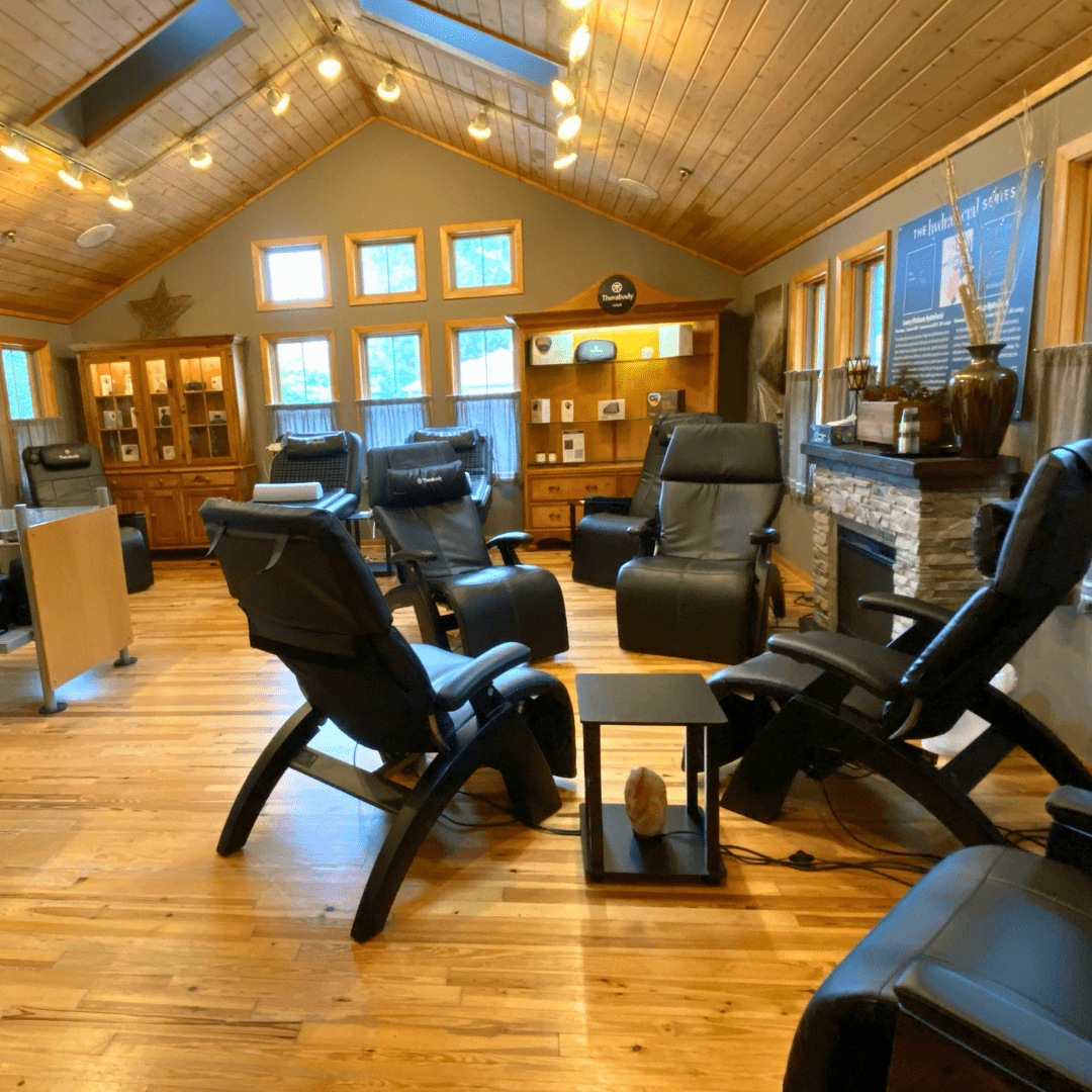 4 black reclining chairs in circle in front of fireplace