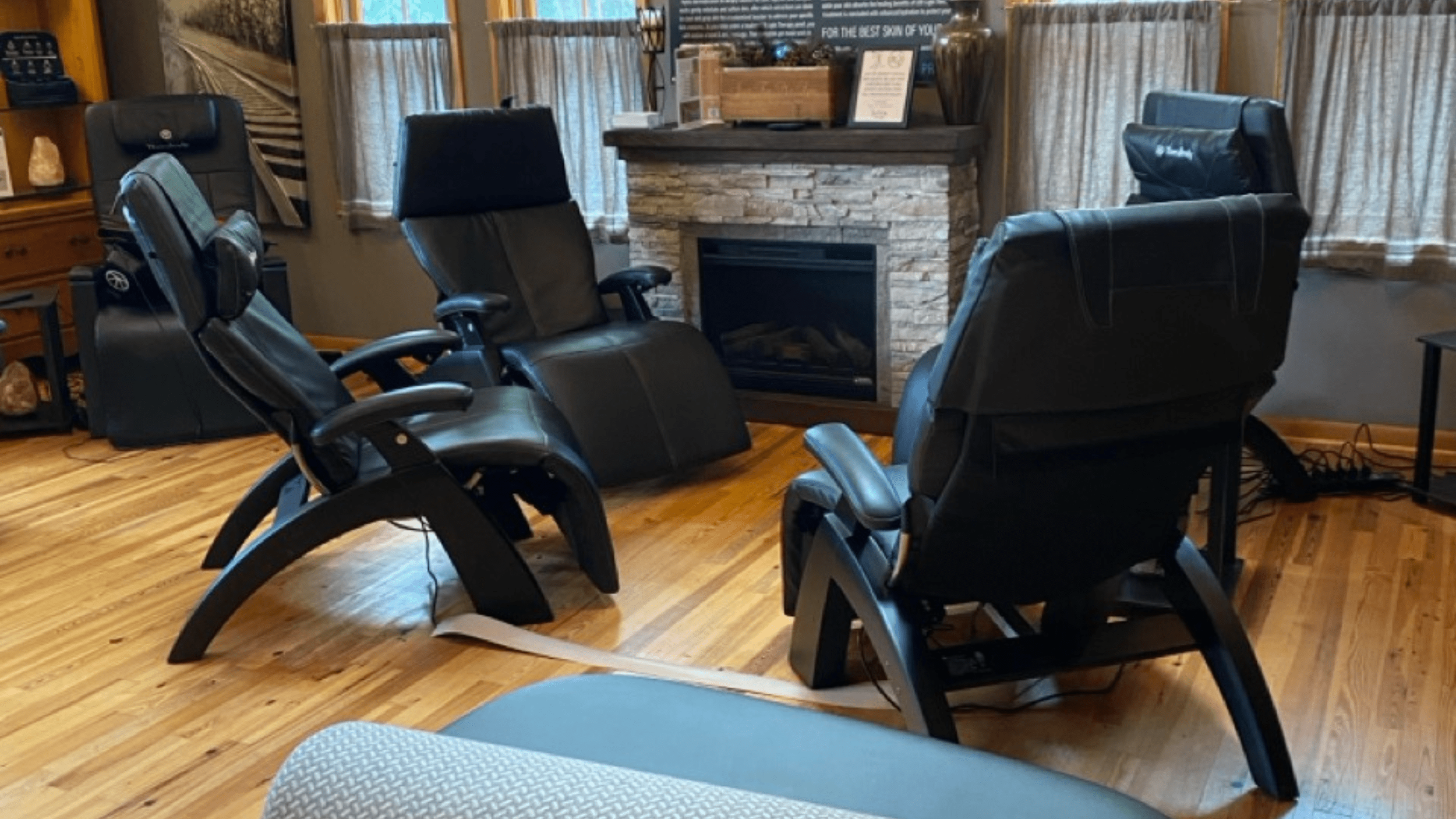 4 reclining chairs near fireplace in rebalancing room