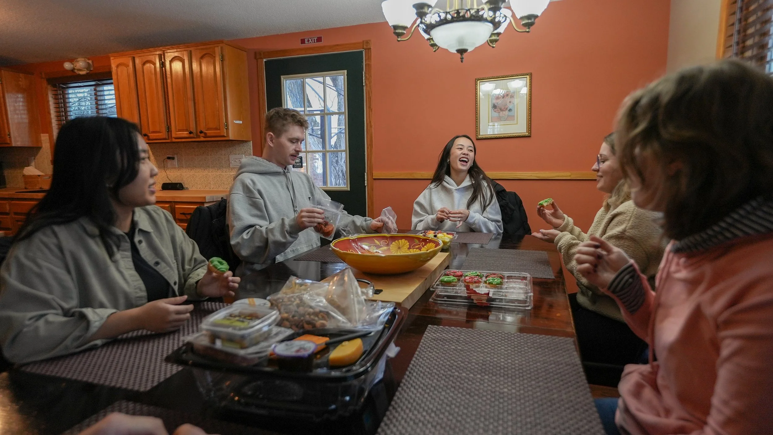 group of people having snacks at table