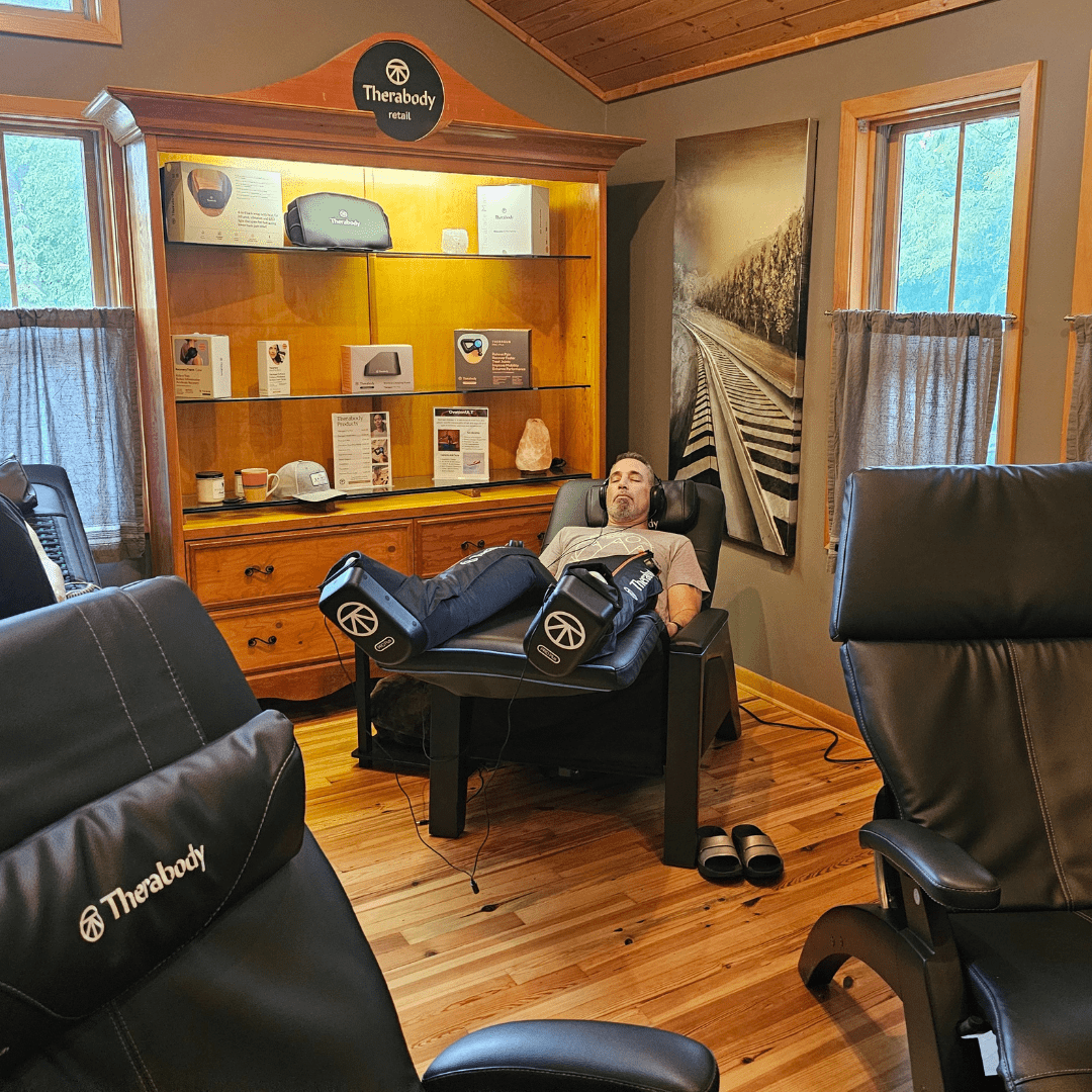 individual experiencing sound & vibration therapy with compression boots