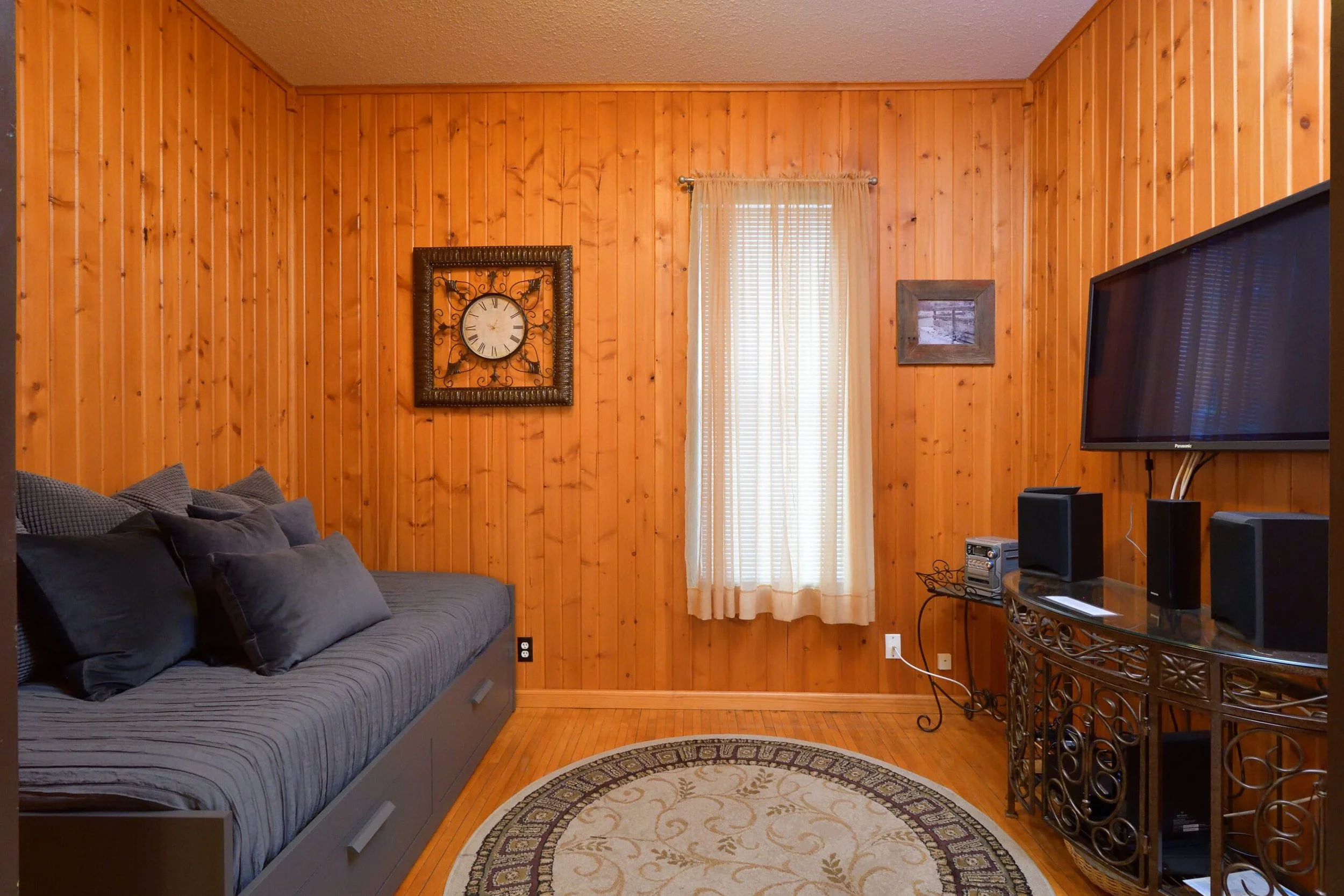 Living room with couch and TV in The Log Cabin home