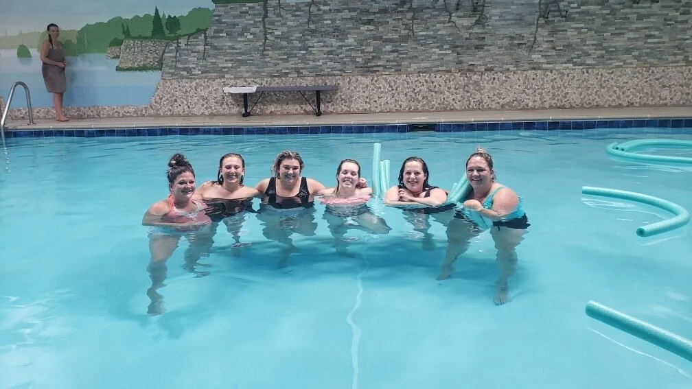 group of woman smiling in mineral pool