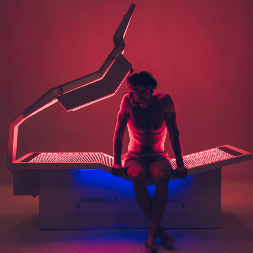 man sitting in infrared light therapy bed