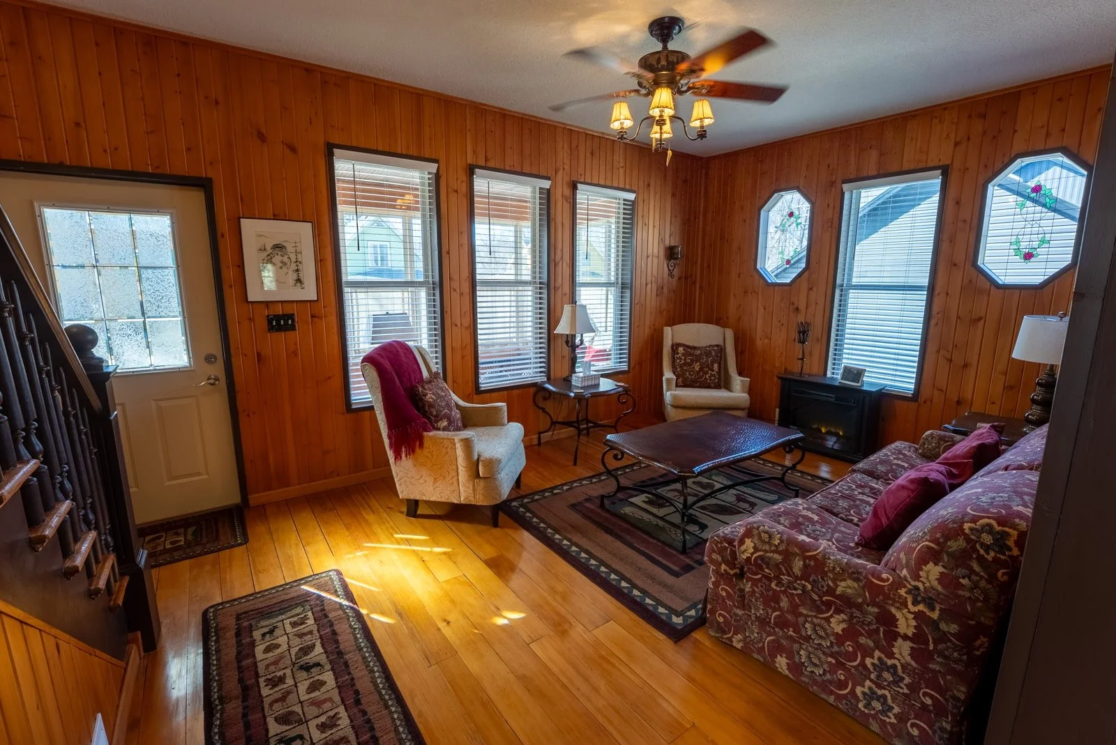 Front room/seating area with two chairs and couch in The Log Cabin home